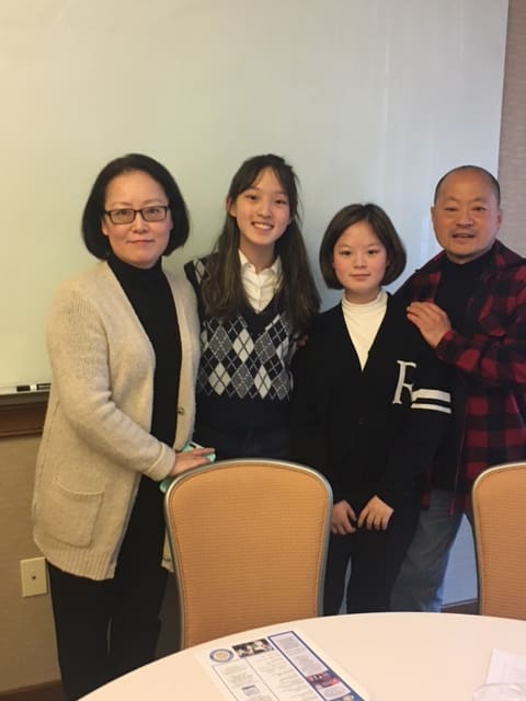 Emily Kim, winner of both Sunrise Optimist Club and Optimist District Oratorical Contest, shown here with her family